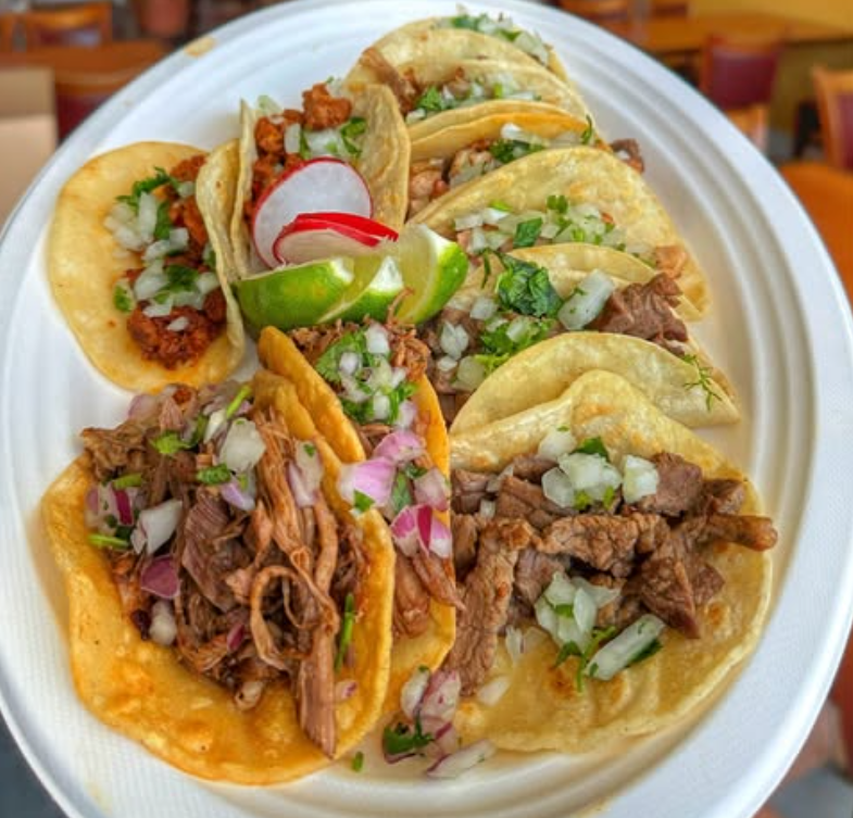 Meat tacos served on a plate.